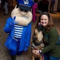 Lady and her dog pose with Louie the Laker